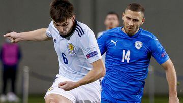Scotland&#039;s defender Kieran Tierney (L) crosses the ball as he is closed down by Israel&#039;s forward Shon Weissman during the UEFA Nations League B Group 2 football match between Israel and Scotland at the Netanya Municipal Stadium in the Israeli ci