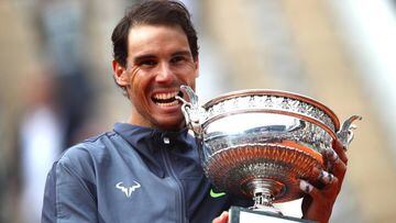 PARIS, FRANCE - JUNE 09: Rafael Nadal of Spain bites the winners trophy after victory following the mens singles final against Dominic Thiem of Austria during Day fifteen of the 2019 French Open at Roland Garros on June 09, 2019 in Paris, France. (Photo b