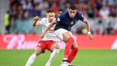 DOHA, QATAR - DECEMBER 04: Kylian Mbappe of France battles for possession with Matty Cash of Poland during the FIFA World Cup Qatar 2022 Round of 16 match between France and Poland at Al Thumama Stadium on December 04, 2022 in Doha, Qatar. (Photo by Laurence Griffiths/Getty Images)