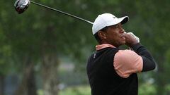 FILE PHOTO: May 21, 2022; Tulsa, OK, USA; Tiger Woods plays his shot from the ninth tee as rain falls during the third round of the PGA Championship golf tournament at Southern Hills Country Club. Mandatory Credit: Michael Madrid-USA TODAY Sports/File Photo