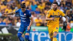 Andre Pierre Gignac (R) of Tigres vies for the ball with Alexis Pena (L) of Necaxa during the  Mexican Apertura 2022 football tournament match at the Universitario stadium in Monterrey, Mexico, on August 27,  2022. (Photo by Julio Cesar AGUILAR / AFP)