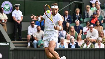 Spain's Rafael Nadal returns the ball to Argentina's Francisco Cerundolo during their men's singles tennis match on the second day of the 2022 Wimbledon Championships at The All England Tennis Club in Wimbledon, southwest London, on June 28, 2022. (Photo by Glyn KIRK / AFP) / RESTRICTED TO EDITORIAL USE