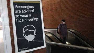 LONDON, ENGLAND - MAY 18: A commuter wears a protective face mask at Waterloo station on May 18, 2020 in London, England. The British government has started easing the lockdown it imposed two months ago to curb the spread of Covid-19, abandoning its &#039