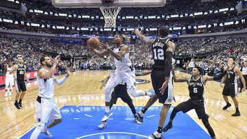 Nov 14, 2017; Dallas, TX, USA; Dallas Mavericks guard Dennis Smith Jr. (1) drives to the basket past San Antonio Spurs forward LaMarcus Aldridge (12) and guard Dejounte Murray (5) during the second half at the American Airlines Center. The Spurs defeat th