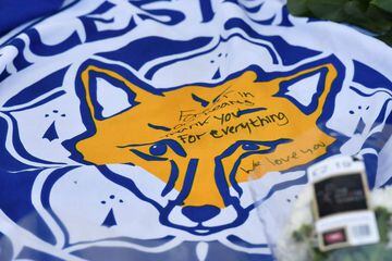 A flag showing the Leicester City Football Club's Fox logo with a message of thanks is seen in a growing pile of tributes outside Leicester City Football Club's King Power Stadium in Leicester