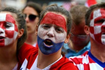 A woman cheers as people gather for a "heroes' welcome" in tribute to Croatian national football team, after reaching the final at the Russia 2018 World Cup, at the Bana Jelacica Square in Zagreb, on July 16, 2018.  / AFP PHOTO / Dimitar DILKOFF