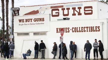LOS ANGELES, CALIFORNIA - MARCH 15: People stand in line outside the Martin B. Retting, Inc. guns store on March 15, 2020 in Culver City, California. The spread of COVID-19 has prompted some Americans to line up for supplies in a variety of stores.   Mari