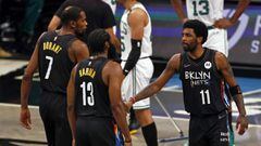 Brooklyn Nets guard James Harden, Kyrie Irving (11) and forward Kevin Durant react after a basket against the Boston Celtics in the first half of Game 5 during an NBA basketball first-round playoff series, Tuesday, June 1, 2021, in New York. (AP Photo/Ada