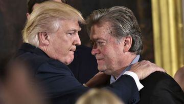 (FILES) In this file photo taken on January 22, 2017 US President Donald Trump (L) congratulates Senior Counselor to the President Stephen Bannon during the swearing-in of senior staff in the East Room of the White House in Washington, DC. - President Don