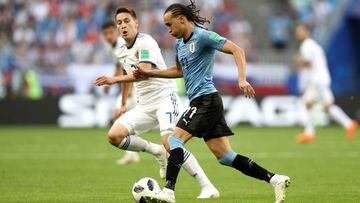 SAMARA, RUSSIA - JUNE 25:  Diego Laxalt of Uruguay challenge for the ball with Daler Kuziaev of Russia  during the 2018 FIFA World Cup Russia group A match between Uruguay and Russia at Samara Arena on June 25, 2018 in Samara, Russia.  (Photo by Maddie Me