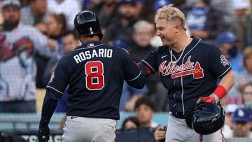 LOS ANGELES, CALIFORNIA - OCTOBER 20: Eddie Rosario #8 of the Atlanta Braves is congratulated by Joc Pederson #22 following a solo home run against the Los Angeles Dodgers during the second inning at Dodger Stadium on October 20, 2021 in Los Angeles, Cali