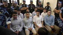 Defendants accused of the murder of Fernando Baez Sosa Ciro Pertossi (front, L), Matias Benicelli (front, 2-L), Blas Cinalli (front, 2-R), Lucas Pertossi (front, R), Ayrton Viollaz (back, L), Maximo Thomsen (back, 2-L), Enzo Comelli (back, 2-R) and Luciano Pertossi (back, R) hear their sentence at the court in Dolores, Buenos Aires province, Argentina on February 6, 2023.