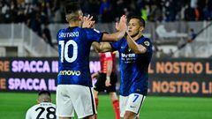 Inter Milan's Chilean forward Alexis Sanchez celebrates with Inter Milan's Argentine forward Lautaro Martinez after scoring during the Italian Serie A football match between Spezia and Inter on April 15, 2022 at the Alberto-Picco stadium in La Spezia, Liguria. (Photo by Alberto PIZZOLI / AFP)