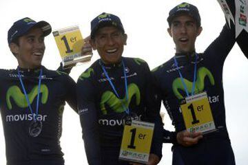 Colombia's Nairo Quintana (C), Spain's Jose Herrada Lopez (L) and Spain's Jonathan Castroviejo (R) of the Spanish Movistar cycling team celebrate on the podium the best team award, on the Champs-Elysees avenue in Paris, at the end of the 109,5 km twenty-first and last stage of the 102nd edition of the Tour de France cycling race on July 26, 2015, between Sevres and Paris. AFP PHOTO / JEFF PACHOUD