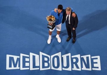 Djokovic (left) poses with the Norman Brookes Trophy and tournament director Craig Tiley after winning the 2015 men's Australian Open singles title. The Serb has won the last three men's singles titles in Melbourne, and nine in total.