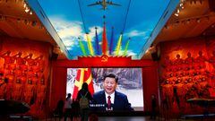 Visitors stand in front of a giant screen displaying Chinese President Xi Jinping next to a flag of the Communist Party of China, at the Military Museum of the Chinese People's Revolution in Beijing, China October 8, 2022. REUTERS/Florence Lo