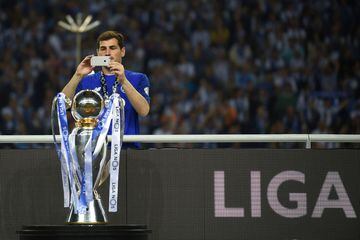 Porto's Spanish goalkeeper Iker Casillas takes a picture of the trophy after winning the league title following the Portuguese league football match between FC Porto and CD Feirense at the Dragao stadium in Porto on May 6, 2018. 