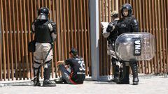 Security forces detain a River Plate&#039;s supporter outside the Monumental stadium in Buenos Aires, after the all-Argentine Copa Libertadores second leg final match against Boca Juniors was postponed on November 25, 2018. - The second leg of the Copa Libertadores final has been postponed for the second time in as many days following an attack on the Boca Juniors team bus by River Plate fans, Conmebol said Sunday. (Photo by Juan Mabromata / AFP)