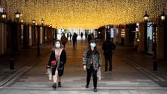 People wearing face masks walk along Hanjie shopping street in Wuhan, in China&#039;s central Hubei province on April 3, 2020. - Wuhan, the central Chinese city where the coronavirus first emerged last year, partly reopened on March 28 after more than two