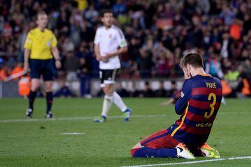 Barcelona's defender Gerard Pique kneels with his face in his hands during the game against Valencia