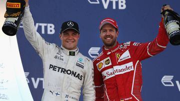 SOCHI, RUSSIA - APRIL 30: Race winner Valtteri Bottas of Finland and Mercedes GP celebrates with second placed finiser Sebastian Vettel of Germany and Ferrari on the podium during the Formula One Grand Prix of Russia on April 30, 2017 in Sochi, Russia.  (Photo by Mark Thompson/Getty Images)