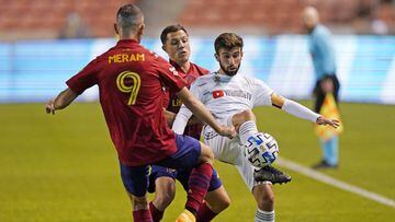 Real Salt Lake&#039;s Justin Meram (9) and Donny Toia, rear, defend against Los Angeles FC forward Diego Rossi, right, during the first half of an MLS soccer match Wednesday, Sept. 9, 2020, in Sandy, Utah. (AP Photo/Rick Bowmer)