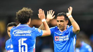 Jesus Escoboza (R) of Cruz Azul celebrates after scoring against Pumas during their Mexican Clausura 2023 tournament football match at the Azteca stadium in Mexico City, on March 11, 2023. (Photo by CLAUDIO CRUZ / AFP)