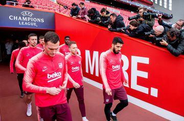 Barcelona players enter the pitch at Anfield for Monday evening's training session.