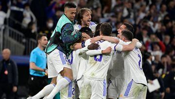 Real Madrid's Dominican forward Mariano Diaz (L) and Real Madrid's Croatian midfielder Luka Modric (2nd-L) celebrate with teammates at the end of the UEFA Champions League semi-final second leg football match between Real Madrid CF and Manchester City at the Santiago Bernabeu stadium in Madrid on May 4, 2022.