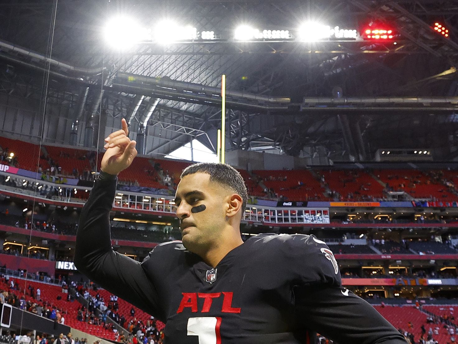 First look: Atlanta Falcons newly signed quarterback Marcus Mariota holding  his Falcons jersey, speaking with media