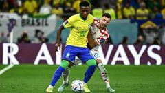 Brazil's forward #20 Vinicius Junior and Croatia's defender #22 Josip Juranovic fight for the ball during the Qatar 2022 World Cup quarter-final football match between Croatia and Brazil at Education City Stadium in Al-Rayyan, west of Doha, on December 9, 2022. (Photo by Jewel SAMAD / AFP) (Photo by JEWEL SAMAD/AFP via Getty Images)