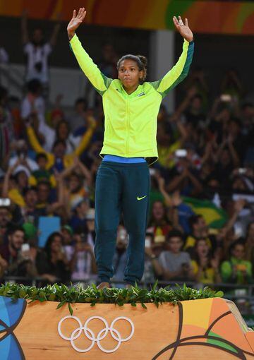 RIO DE JANEIRO, BRAZIL - AUGUST 08: Rafaela Silva of Brazil celebrates on the podium after winning the gold medal in the Women's -57 kg Final - Gold Medal Contest on Day 3 of the Rio 2016 Olympic Games at Carioca Arena 2 on August 8, 2016 in Rio de Janeir