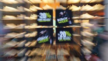 A poster with the words "Black Week" hangs in the window of a downtown store. November 25 is "Black Friday," and retailers are once again advertising deals.