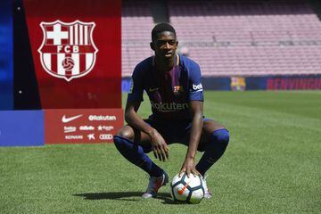 Barcelona's new player Ousmane Dembele poses with a ball at the Camp Nou stadium in Barcelona, during his official presentation by the Catalan football club, on August 28, 2017.st after the German club rejected Barca's first bid.