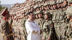 HANDOUT - 27 April 2022, North Korea, Pyongyang: A picture provided by the North Korean state news agency (KCNA) on 29 April 2022, shows North Korean leader Kim Jong-un, wearing a white marshal&#039;s uniform, standing in front of soldiers during a photo 