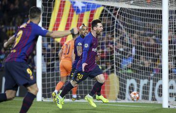 Lionel Messi of Barcelona celebrates his second goal with Arturo Vidal during the UEFA Champions League Round of 16 Second Leg match between FC Barcelona and Olympique Lyonnais