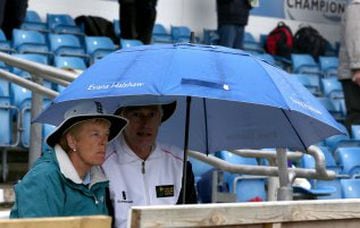 Fans shelter under umbrellas as rain stops play after the tea interval during day one of the first cricket Test  between England and Sri Lanka at Headingley, Leeds England,