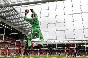 Liverpool goalkeeper Adrián pushes the header from Bournemouth defender Nathan Ake on to the crossbar.