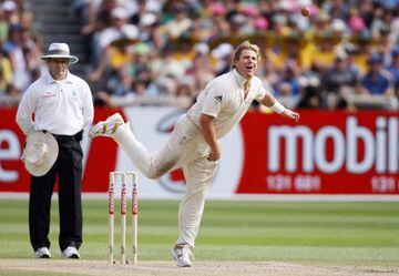 (FILES) In this file photograph taken on December 28, 2006, Australian spinner Shane Warne (R) sends down a delivery as umpire Aleem Dar (L) looks on as Warne plays his last Test match on his home ground, the MCG, on the third day of the fourth cricket Te