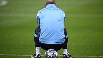 Manchester City's Spanish manager Pep Guardiola sits on a ball as he takes part in a team training session at Manchester City training ground in Manchester, north-west England on June 6, 2023, ahead of their UEFA Champions League final football match against Inter Milan. (Photo by Paul ELLIS / AFP)