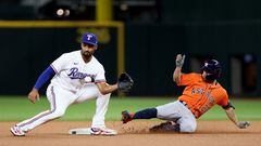Houston Astros second baseman Jose Altuve (27) slides into second for a double in front of Texas Rangers second baseman Marcus Semien (2)
