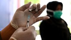 A police health worker prepares to vaccinate an inmate with a dose of the Sinovac Covid-19 vaccine at a prison in Lhoknga, Indonesia&#039;s Aceh province on October 2, 2021.