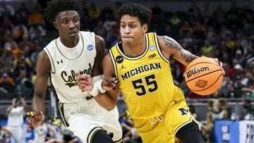 Mar 17, 2022; Indianapolis, IN, USA; Michigan Wolverines guard Eli Brooks (55) controls the ball against Colorado State Rams guard Kendle Moore (3) in the second half during the first round of the 2022 NCAA Tournament at Gainbridge Fieldhouse. Mandatory C