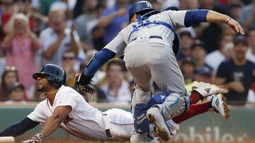 Boston Red Sox&#039;s Xander Bogaerts, left, scores against Los Angeles Dodgers&#039; Russell Martin, right, during the first inning of a baseball game in Boston, Sunday, July 14, 2019. (AP Photo/Michael Dwyer)