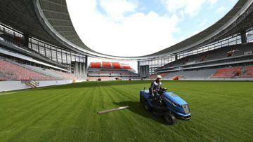 An employee cuts grass on the pitch of Ekaterinburg Arena, the stadium under construction which will host matches of the 2018 FIFA World Cup in the city of Yekaterinburg, Russia September 18, 2017. REUTERS/Stringer