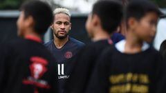 (FILES) In this file photo taken on August 2, 2019 Paris Saint-Germain&#039;s Brazilian forward Neymar (C) plays with children before a training session at the Shenzhen Universiade Stadium in Shenzhen on the eve of the French Trophy of Champions football 