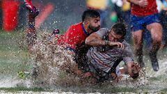 The USA's Cam Dolan (R) is tackled by Chile's Franco Velarde during their Rugby World Cup 2023 Americas 2 play-off first leg match, at the Santa Laura Universidad SEK stadium, in Santiago, on July 9, 2022.