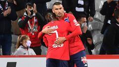Lille&#039;s Turkish forward Burak Yilmaz (R) celebrates with Lille&#039;s French midfielder Jonathan Bamba after scoring a penalty during the French L1 football match between Lille OSC (LOSC) and FC Nantes (FCN) at the Stade Pierre Mauroy in Lille, north