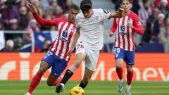 Atletico Madrid's Brazilian forward #12 Samuel Lino vies with Sevilla's Spanish midfielder #26 Juanlu Sanchez during the Spanish league football match between Club Atletico de Madrid and Sevilla FC at the Metropolitano stadium in Madrid on December 23, 2023. (Photo by Pierre-Philippe MARCOU / AFP)