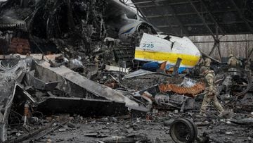 A Ukrainian service member walks in a front of an Antonov An-225 Mriya cargo plane, the world&#039;s biggest aircraft, destroyed by Russian troops as Russia&#039;s attack on Ukraine continues, at an airfield in the settlement of Hostomel, in Kyiv region, 